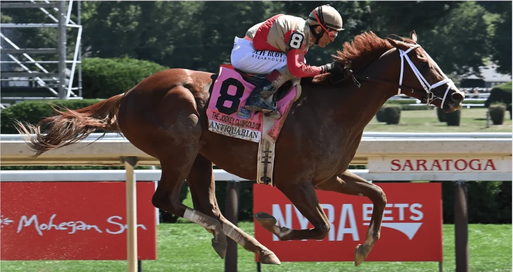 antiquarian with a jockey on him running in a race